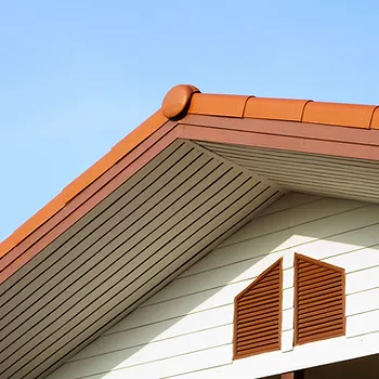 Red roof house with newly installed gutters